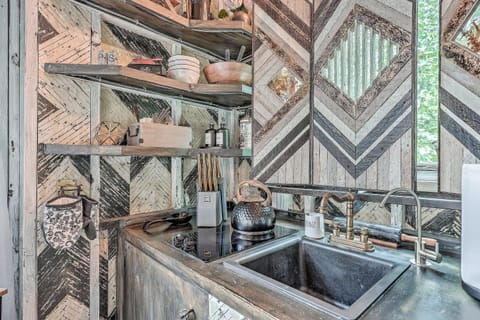 Enjoy the convenience of a full array of modern appliances, including a high-quality stovetop and sleek matte-black faucet.