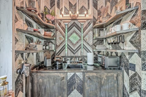 Prepare a meal in our well-stocked kitchen, featuring elegant dark cabinetry and high-end finishes throughout.