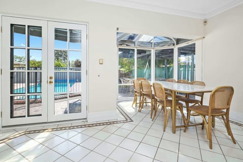 Open Plan Dining and Kitchen Area - with Fully equipped kitchen, 8 seater dining table and mounted SAMSUNG frame TV