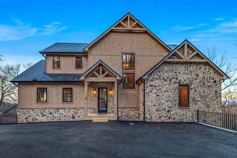 Welcome to Wellevate Lodge, a luxurious Smoky Mountain escape! With its rustic wood and stone exterior, metal roof, and warm lighting, this cabin is the perfect blend of modern elegance and mountain charm.