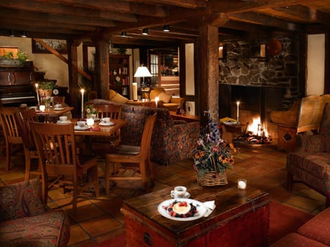 An intimate dining experience awaits in a softly lit restaurant, where warm wooden accents create a welcoming atmosphere.