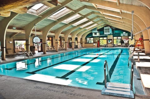 Bright indoor pool with soaring ceilings and abundant natural light, perfect for a relaxing swim in any season.