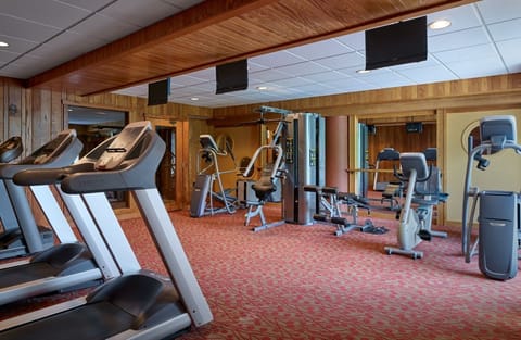 Well-equipped fitness center with natural light and modern machines, offering a comfortable space to stay active.
