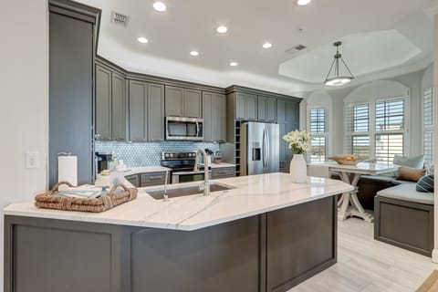 Luxury Kitchen with Stunning Quartz Countertops, Custom Cabinetry, and Stainless Steel Appliances