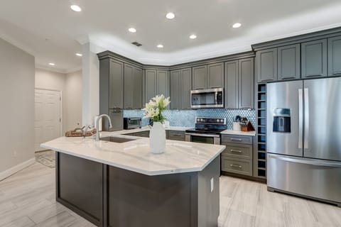 Luxury Kitchen with Stunning Quartz Countertops, Custom Cabinetry, and Stainless Steel Appliances