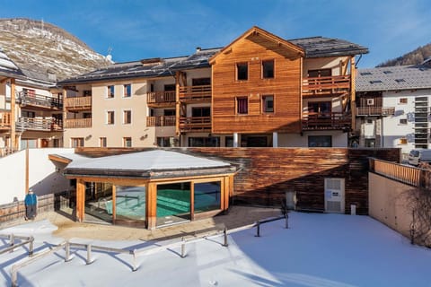 A stunning winter view of Les Balcons du Viso, perfectly blending into the snowy landscape of the Queyras Regional Park.