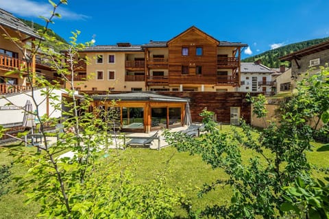 The residence in its summer glory, with a beautiful garden space enhancing its alpine charm.