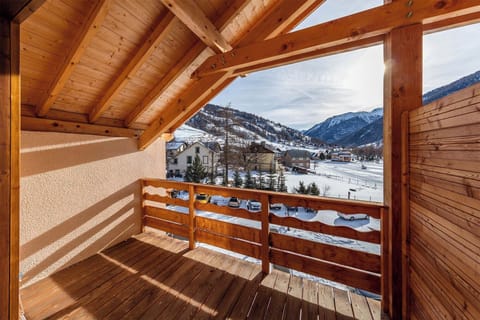 Step onto the private balcony to take in breathtaking panoramic views of the snow-covered mountains.