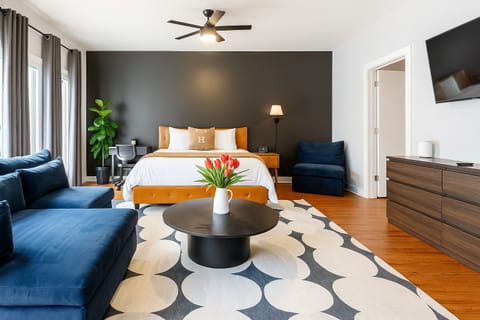 Spacious 594 sq ft studio with king bed, lounge area, and modern décor.