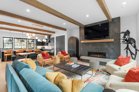 Gather by the fireplace or around the dining table in this bright, open living space where modern comfort meets rustic warmth.