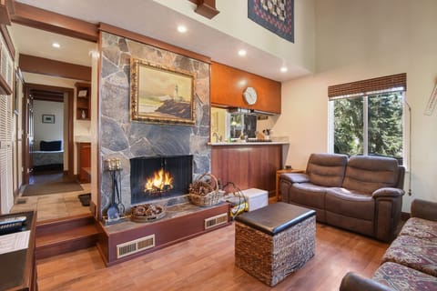 Cozy and spacious living area with TV and fireplace