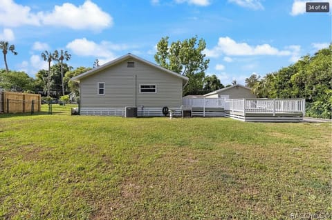 Back of house, porch to the right, full fence of back yard
