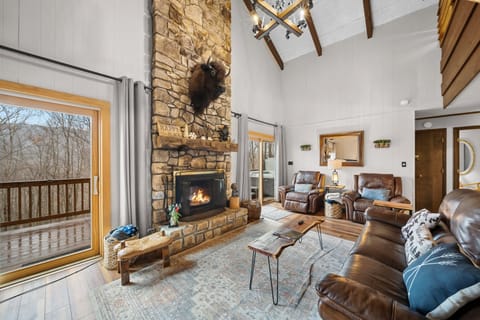 Leather Furniture and Stacked-Stone Fireplace with Mountain Charm