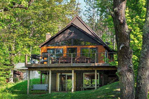 Enjoy a cozy cabin feel with a spacious deck, outdoor seating, and peaceful nature all around.