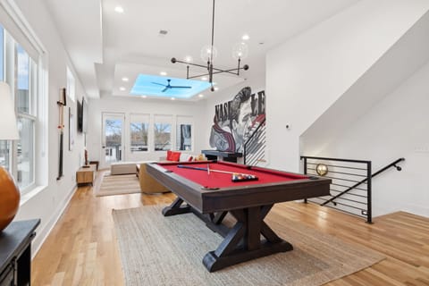 Living Room: Challenge your friends to a game of pool while enjoying the open-concept design and Nashville-inspired artwork.