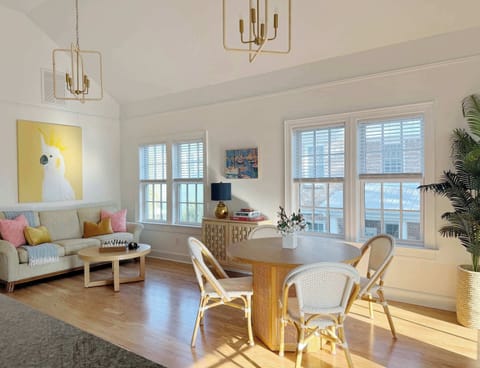 Open floor plan encourages connection and flow between all living spaces in this colorful property. Large windows and high ceilings only add to this. 