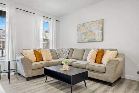 Living room with a 65` Smart TV and cozy seating options.
