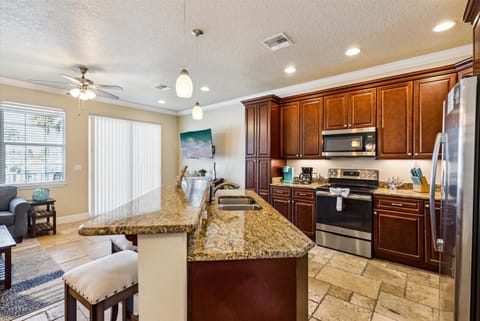 Fully stocked with stainless appliances and rich wood cabinetry—it's cooking made effortless.