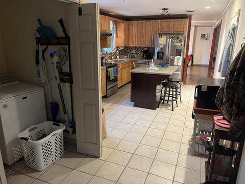 Kitchen with 2 Bar Stools at Island & Laundry Closet