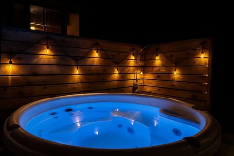 5. A privacy screen and lighting set the tone for a relaxing dip in the hot tub!