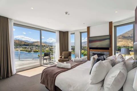The fabulous master bedroom... north facing for direct sunshine year round.  The room features a gas fireplace and wall mounted smart tv.  The curtains can be drawn to block out the light.