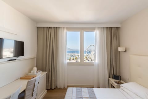 Double or Twin Room, Partial Sea View | Minibar, in-room safe, desk, soundproofing