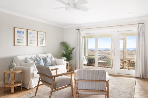 Spacious living room with plush seating, elegant decor and large windows