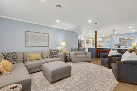 Living room with a sectional couch and three armchairs