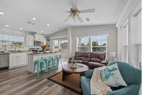 Living Room: Bright and airy space with stylish seating and a flat-screen TV for relaxation!