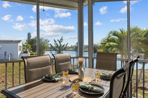 Enjoy meals on this charming screened porch overlooking tranquil waters!