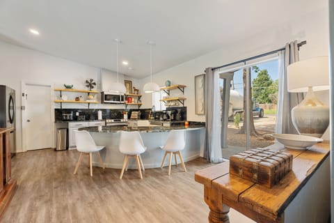 Gather around in this open-concept dining and kitchen space, designed for shared meals and warm conversations.