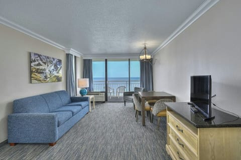The private balcony off the living room invites you to step outdoors.