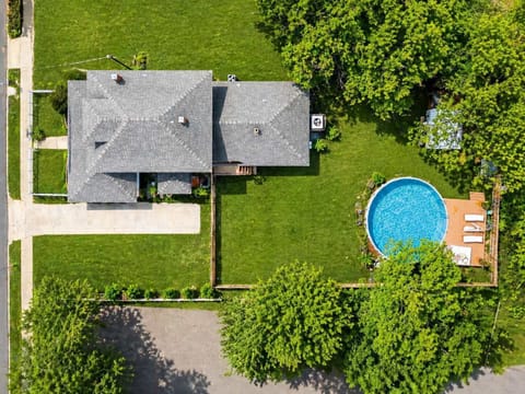 Aerial view of the home and yard with above ground pool