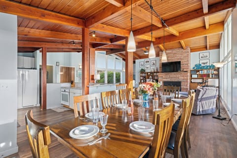 Dining area with ocean view open to living room and kitchen