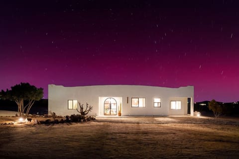 The desert keeps its most magical moments for those who stay long enough — a purple sky, a glowing adobe, and silence in every direction.