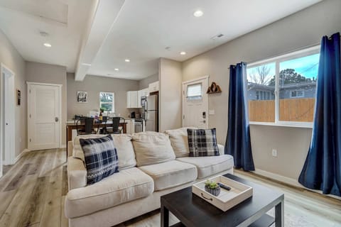 Bright and comfortable living area with stylish seating, a Smart TV, and a cozy atmosphere for unwinding.





