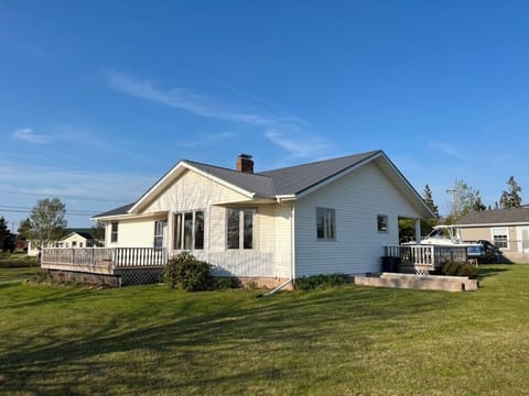 View of bay facing side of house with front deck.