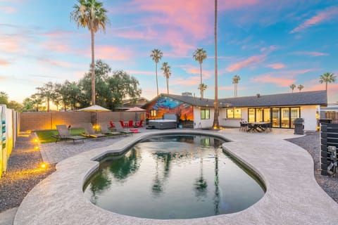 Spacious backyard patio with poolside dining and sunset views