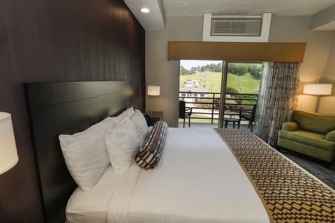 Cozy guest room with a plush bed and a private balcony, perfect for relaxation.