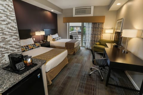 Spacious guest room with modern amenities, two comfortable beds, and a convenient workspace.