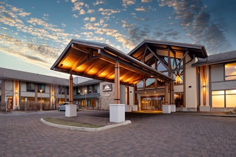 A warm welcome awaits beneath the beautifully lit entrance of this mountain retreat.