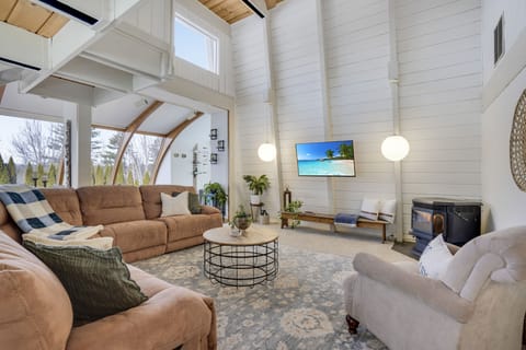 SPACIOUS LIVING ROOM WITH PLENTY OF SEATING AND A PELLET STOVE