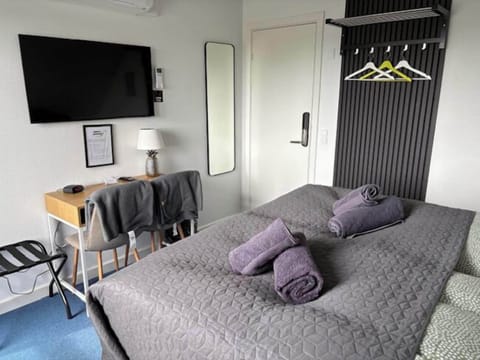 Desk, laptop workspace, blackout drapes, iron/ironing board