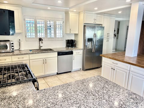 Open concept kitchen with ice maker fridge,gas stove,dishwasher & coffee station
