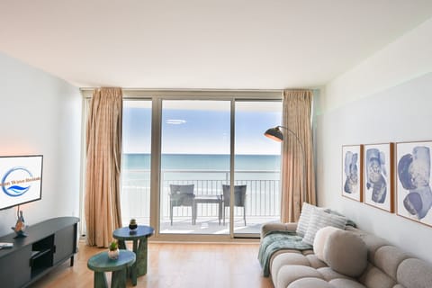 Cozy living room with balcony offering beautiful ocean views
