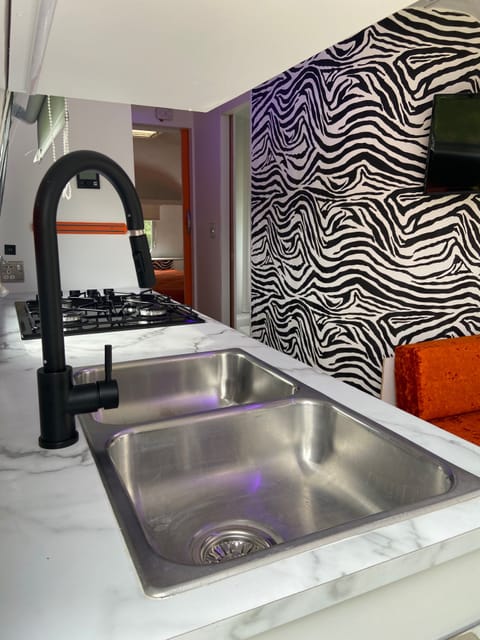 Kitchen Area with Cooker, fridge, drinks fridge and seating area