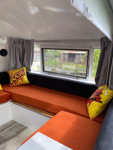 Seating area which pulls out to accommodate  a double sleeping area