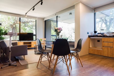 Modern living space with large windows and lush views, perfect for relaxation and entertainment.