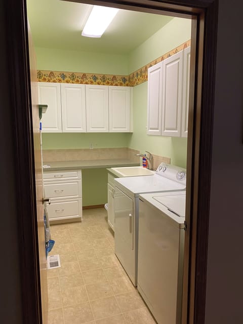 Laundry room with iron and ironing board