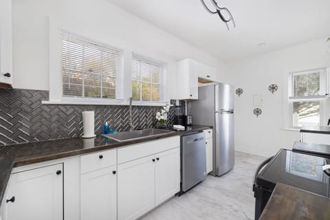 The kitchen is updated with new flooring and backsplash.
